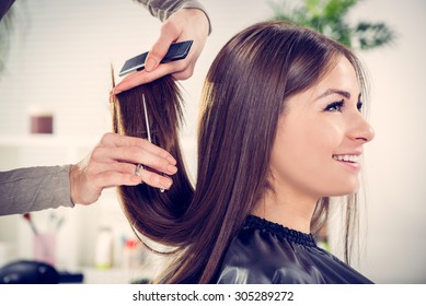 Young beautiful woman having her hair cut at the hairdresser's. - Shutterstock ID 305289272