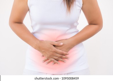 Young beautiful woman having painful stomachache on white background.Chronic gastritis. Abdomen bloating concept.