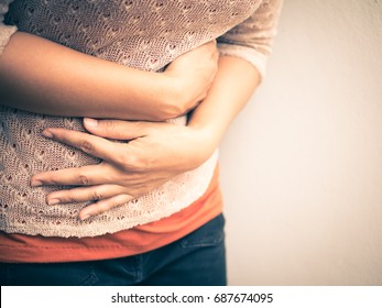 Young beautiful woman having painful stomachache.Chronic gastritis. Abdomen bloating concept.