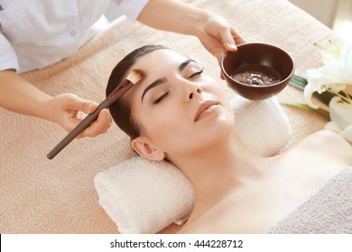 Young beautiful woman having spa procedure on her face