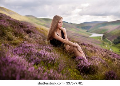 Young Beautiful Woman  In The Heather Meadows In Scotland