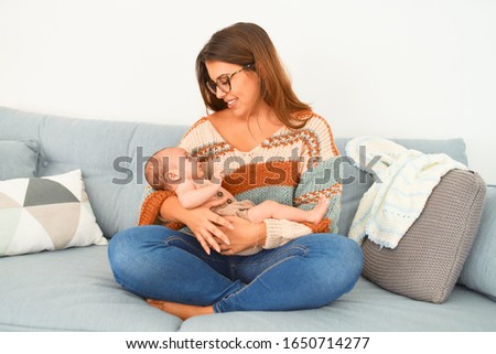 Similar – Image, Stock Photo Mother hugging her baby in front of fireplace