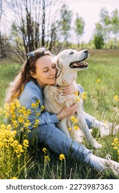 Young beautiful woman and her golden retriever dog having fun in summer - Shutterstock ID 2273987363