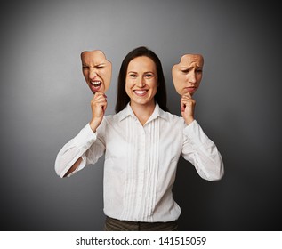 Young Beautiful Woman Hiding Her Good Mood Under Masks