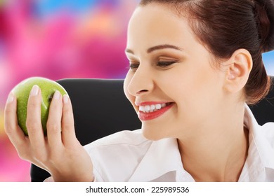 Young beautiful woman holding an apple