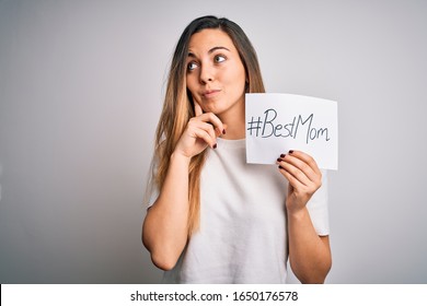 Young Beautiful Woman Holding Paper With Best Mom Message Celebrating Mothers Day Serious Face Thinking About Question, Very Confused Idea
