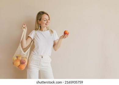 Young Beautiful Woman Holding String Eco Shopping Bag With Fresh Fruits. Healthy Conscious Lifestyle.