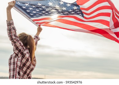 young beautiful woman holding USA flag. - Powered by Shutterstock