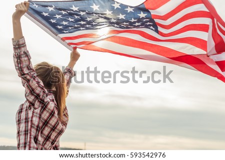young beautiful woman holding USA flag.