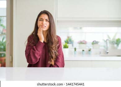 Young Beautiful Woman At Home Touching Mouth With Hand With Painful Expression Because Of Toothache Or Dental Illness On Teeth. Dentist Concept.