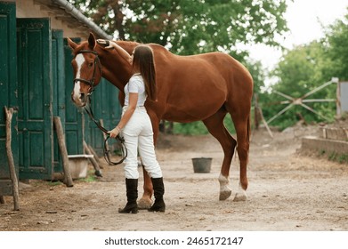 Young beautiful woman is with a horse outdoors. - Powered by Shutterstock