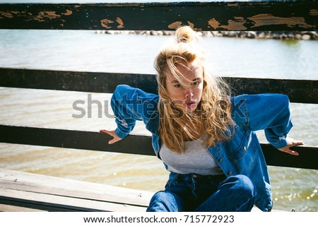 Similar – Young blonde woman in a sunny day in the city