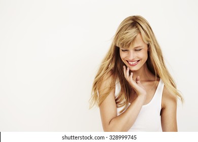 Young beautiful woman laughing in studio