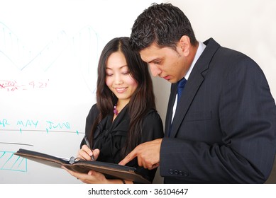 Young beautiful woman and man discussing something near whiteboard - Shutterstock ID 36104647