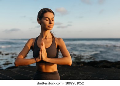 Young Beautiful Woman Meditation On Beach. Bali Indonesia.