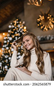 Young Beautiful Woman Model With Long Hair In A Beige Suit Christmas Tree Christmas In Brown Wooden Houses 