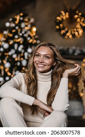 Young Beautiful Woman Model With Long Hair In A Beige Suit Christmas Tree Christmas In Brown Wooden Houses 