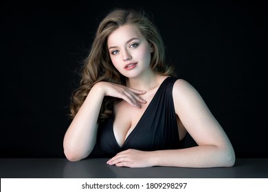 Young beautiful woman with natural makeup on black background. Beauty  Skin care concept. Plus size model.