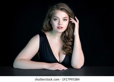 Young Beautiful Woman With Natural Makeup On Black Background. Beauty And Skin Care Concept. Plus Size Model.