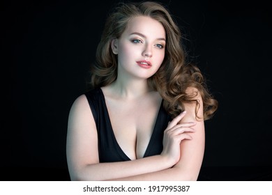 Young Beautiful Woman With Natural Makeup On Black Background. Beauty And Skin Care Concept. Plus Size Model.