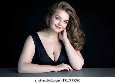 Young Beautiful Woman With Natural Makeup On Black Background. Beauty And Skin Care Concept. Plus Size Model.