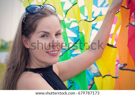 Young beautiful woman on the background of colored ribbons