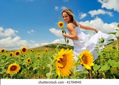 Young Beautiful Woman On Field In Summer