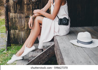 Young Beautiful Woman On Tropical Vacation In Asia, Summer Style, White Boho Dress, Sneakers, Digital Photo Camera, Traveler, Straw Hat, Legs Close Up Details