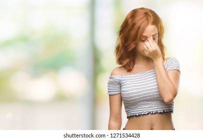 Young beautiful woman over isolated background tired rubbing nose and eyes feeling fatigue and headache. Stress and frustration concept.