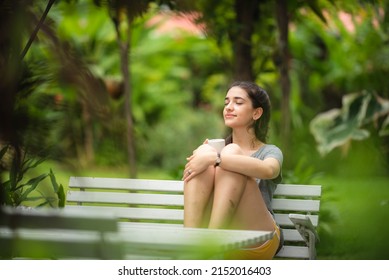young beautiful woman person are happy and enjoy with coffee drink in the morning at home, relax lifestyle by holding coffee or tea cup at nature outdoor park, smile pretty girl with freedom time