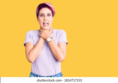 Young beautiful woman with pink hair wearing casual clothes shouting and suffocate because painful strangle. health problem. asphyxiate and suicide concept.  - Shutterstock ID 1814717153