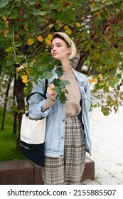 Young Beautiful Woman Pose Outside, Standing In A Blue Jacket