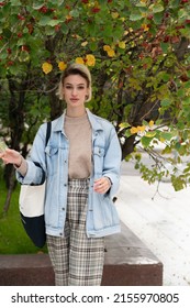 Young Beautiful Woman Pose Outside, Standing In A Blue Jacket