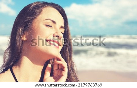 Young beautiful woman posing on the beach in sunset light. Summer tropical mood.