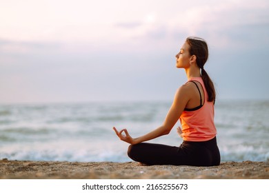 Young beautiful woman practices yoga and meditates on the beach. Sport, Active life.  - Powered by Shutterstock