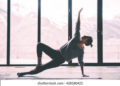 Young beautiful woman practicing yoga with mountain view in the background. Wellness concept. Calmness and relax, woman happiness. Toned picture