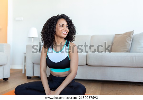 Young beautiful woman in the prayer position. Woman\
practicing yoga, relaxing in prayer position on mat, Padmasana\
exercise girl wearing sportswear working out, meditating in yoga\
studio or at home