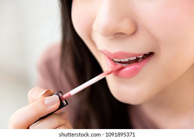 Young Beautiful Woman Professional Beauty Vlogger Or Blogger Applying Lipstick Cream To Her Mouth, Doing A Make Up Tutorial