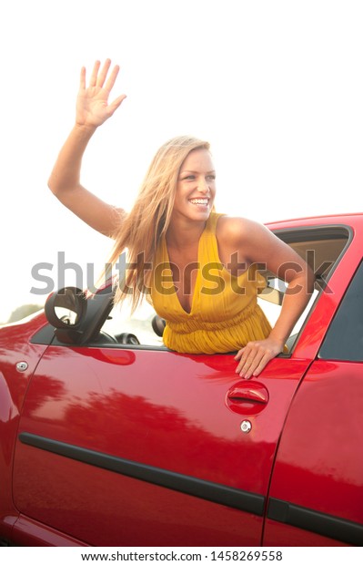 Young\
Beautiful Woman in a Red Car in the\
Nature