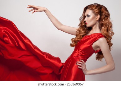 Young Beautiful Woman In Red Dress. 