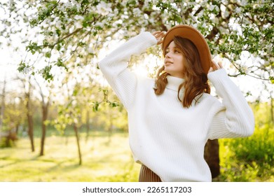 Young beautiful woman relaxing in blooming  garden. Spring,  romantic and lifestyle concept.