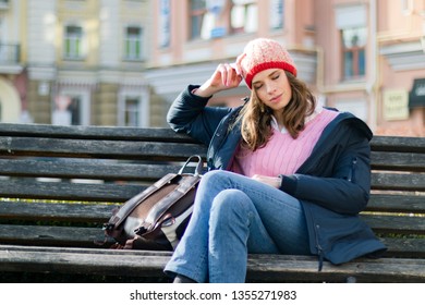 young beautiful woman resting sitting on a bench. - Shutterstock ID 1355271983
