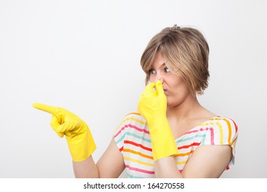 Young Beautiful Woman In Rubber Gloves Holding Her Nose