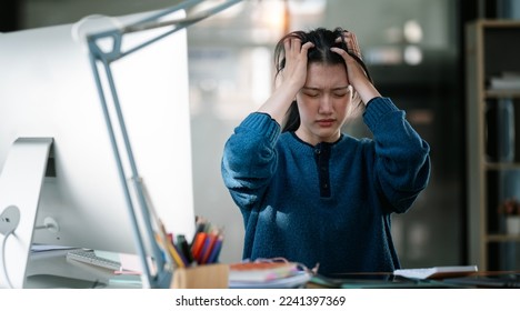 Young beautiful woman sitting at office suffering from headache desperate and stressed because pain and migraine. Hands on head. - Shutterstock ID 2241397369