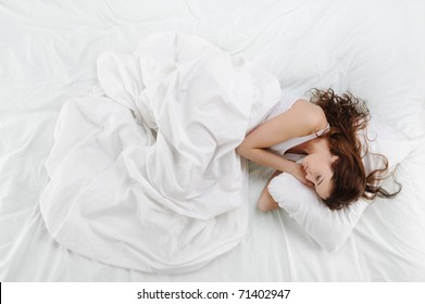 Young Beautiful Woman Sleeping On The Bed