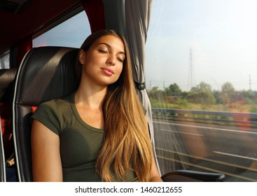 Young Beautiful Woman Sleeping Sitting In The Bus. Bus Passenger Traveling Sitting In A Seat And Sleeping.