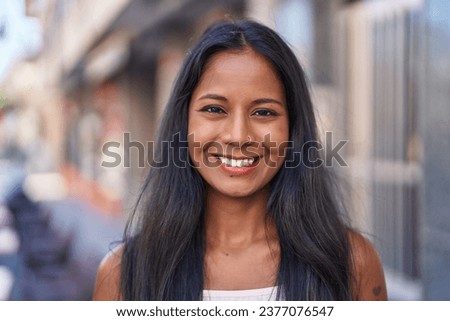 Young beautiful woman smiling confident standing at street