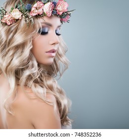 Young Beautiful Woman In Spring Flowers Wreath On Blonde Curly Hair