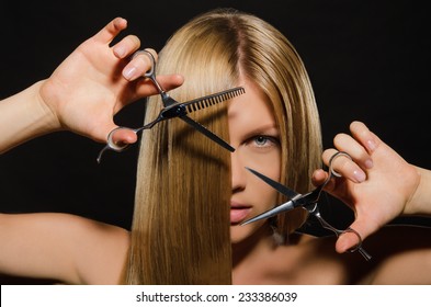 Young Beautiful Woman With Straight Hair And Scissors On Black Background