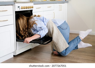 A Young Beautiful Woman Stuck Her Head In The Oven And Checks The Readiness Of The Pie. Humor